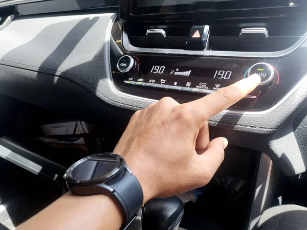 Asian Mans Hand Operating Car Air Conditioning Button — 스톡 사진