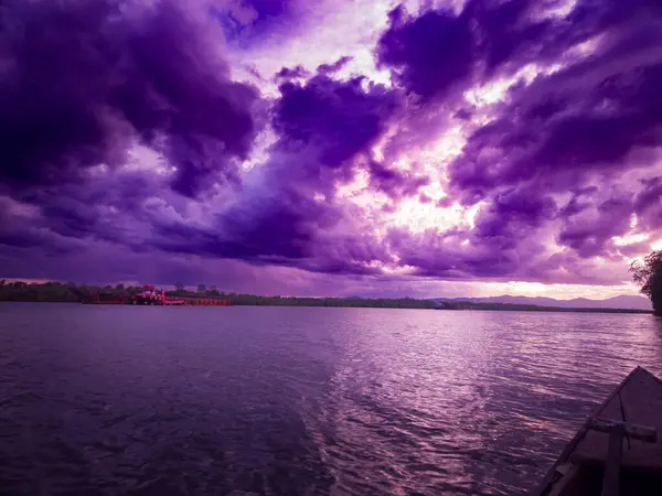 photography of the view of the sunset sky in the afternoon is purple on the sea