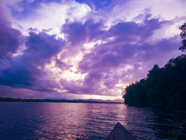 photography of the view of the sunset sky in the afternoon is purple on the sea