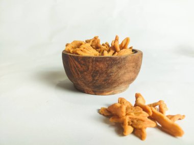 photography of cimi-cimi snack food in a wooden bowl on a white background clipart