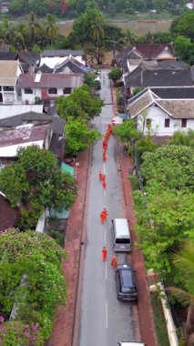 Laos 'taki güzel Luang Prabang' ın güzel sokaklarında sabah sadaka topladıkları sırada gezinen dingin rahiplerin hava manzarası.. 