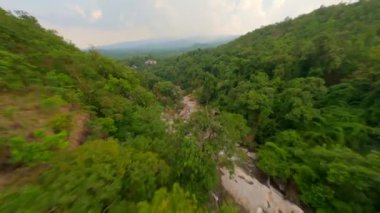 Dinamik FPV insansız hava aracı, Chiang Mai bölgesindeki Tayland 'ın kuzeyinde inanılmaz bir şelale ve tropikal ağaçlar üzerinde uçuyor..