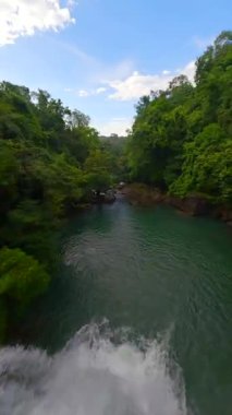 Tayland 'ın yemyeşil ormanları arasında tropikal nehir üzerinde FPV uçuşu.