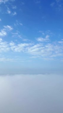 Blue sky gradually turns into white mist as clouds cover the view