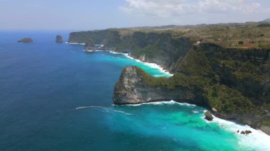 Endonezya, Bali 'deki Nusa Penida Adası' ndaki uçurumların ve turkuaz suyun havadan görünüşü. Seyahat, doğa ve tropikal cennet temaları için muhteşem bir manzara..