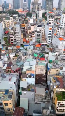 Ho Chi Minh City 'nin gökdelenlerle çelişen yoğun alçak binalarıyla gökdelenler, Vietnam' ın gökdelenleri. Kentsel büyüme, karşıtlık ve mimari temalar.