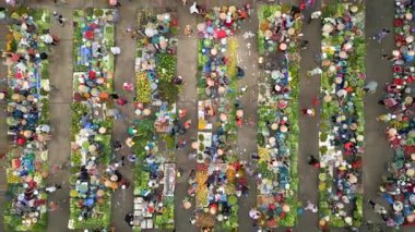 Meyve, sebze ve konik şapkalı insanlarla dolu canlı Vietnam pazarının yukarıdan aşağı görüntüsü. Güneydoğu Asya 'da renkli yerel kültür ve geleneksel sokak ticareti.