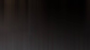 Takım elbiseli ve kravatlı bir adam duvarın önünde duruyor.