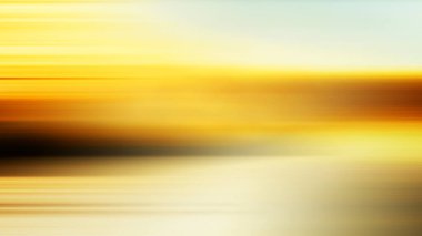 Bir su kütlesinin üzerinde gün batımının bulanık bir görüntüsü.