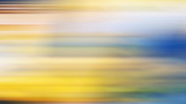 Sarı ve mavi bir otobüsün bulanık fotoğrafı.