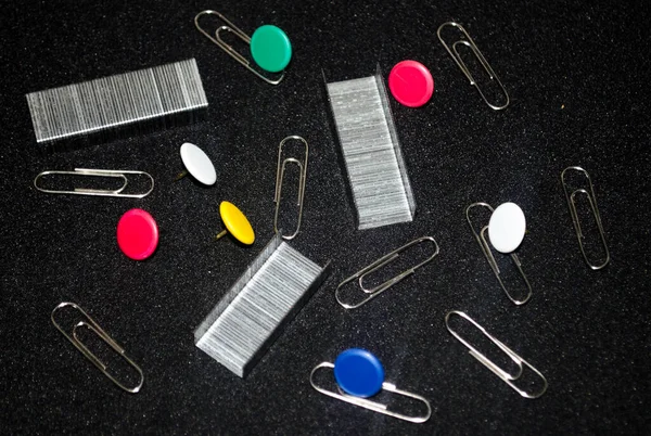 Colored thumb tacks, push pins, office equipment, stationery and tools for work. office supplies