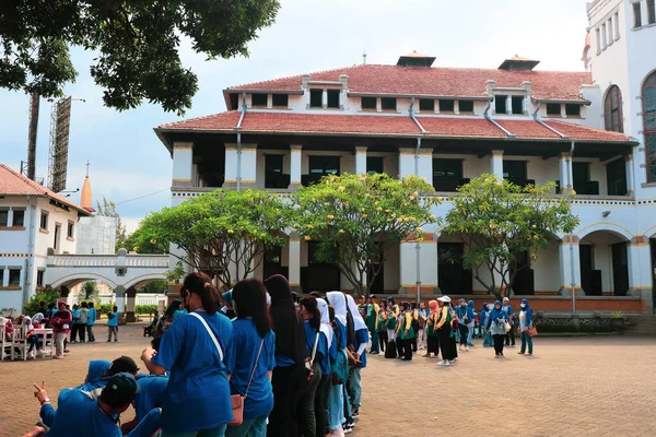 Semarang, December 2022. The atmosphere of the group of tourists together with the tour guide looks at the history of the Lawang Sewu Seribu Pintu building.