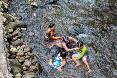Guci, December 2022. View of people bathing in hot springs at the Guci hot spring tourist spot.
