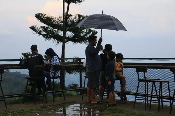 Semarang, December 2022. view of visitors to the umbul sidomukti coffee cottage cafe enjoying food and natural scenery that is cool and fresh