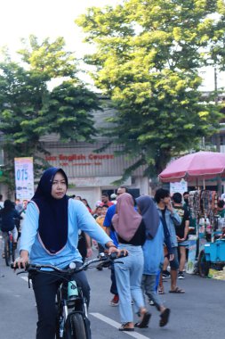 Kudus, December 2022. People on Car Free Day, exercise and relax with family, girlfriends, friends in the town square of Kudus, Indonesia.