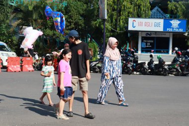 Kudus, December 2022. People on Car Free Day, exercise and relax with family, girlfriends, friends in the town square of Kudus, Indonesia.