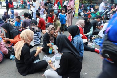 Kudus, December 2022. People on Car Free Day, exercise and relax with family, girlfriends, friends in the town square of Kudus, Indonesia.