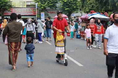 Kudus, December 2022. People on Car Free Day, exercise and relax with family, girlfriends, friends in the town square of Kudus, Indonesia.