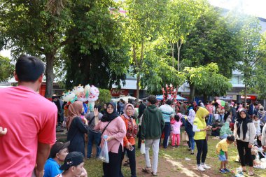 Kudus, December 2022. People on Car Free Day, exercise and relax with family, girlfriends, friends in the town square of Kudus, Indonesia.