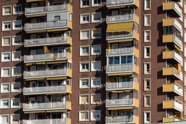 young man reading book on the background of the river in the park.