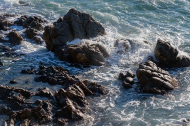 rocky beach, waves crashing on the coast of the sea