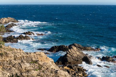 view of the coast of the mediterranean sea. the waves are the sky and the sun.