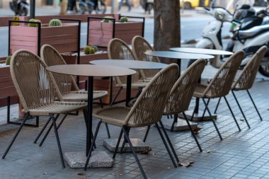 empty outdoor cafe in the morning with table and chairs in the city of Barcelona.