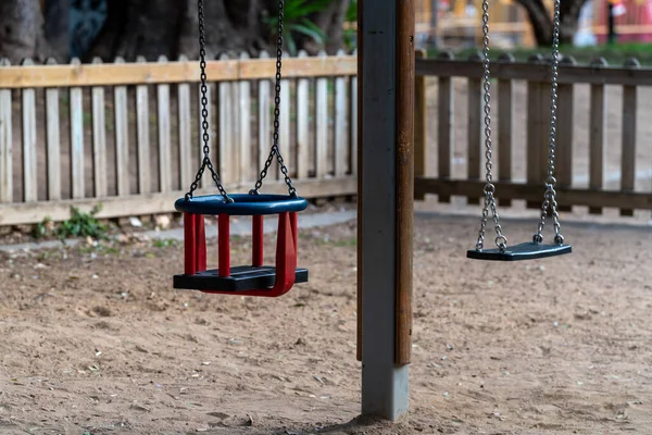 children\'s playground in the park. Empty swing in wooden playground.