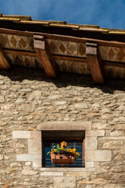 The old wooden house details in the city of Girona, Catalonia, spain. Window of the medieval brick house.