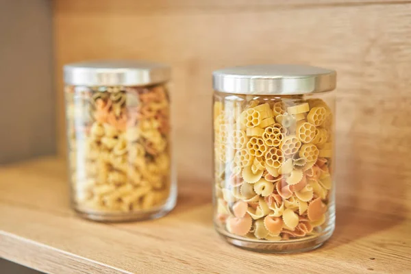 Pantry food cabinet. Kitchen storage organization. Pasta, grains in glass jars. Organic food. Home cooking. Nutrition food. Glass containers. Food preparation. Zero waste, plastic free. High quality