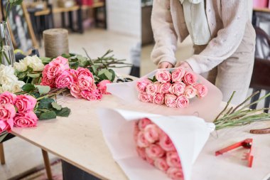 Florist at work. .Summer bouquet of roses. Learning flower arranging, making beautiful bouquets with your own hands. Flowers delivery. High quality photo