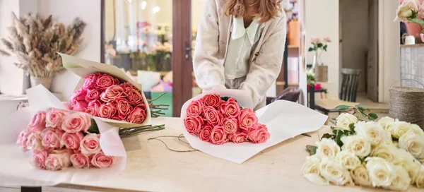 Florist at work. .Summer bouquet of roses. Learning flower arranging, making beautiful bouquets with your own hands. Flowers delivery. High quality photo