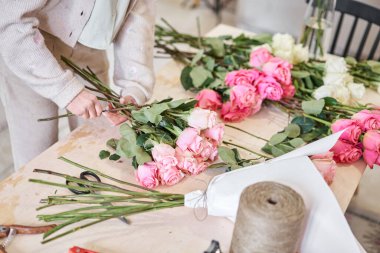 Florist at work. .Summer bouquet of roses. Learning flower arranging, making beautiful bouquets with your own hands. Flowers delivery. High quality photo