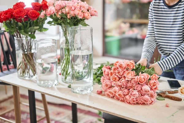 Florist prepares flowers. Fresh delivery in flower shop. High quality photo