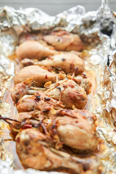 Baked chicken drumsticks without skin and chicken breast. Baked in foil with onions and seasonings. Home cooking. Healthy food, cooked without oil and salt. . High quality photo