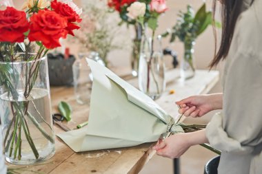 Florist at work. .Summer bouquet of roses. Learning flower arranging, making beautiful bouquets with your own hands. Flowers delivery. High quality photo