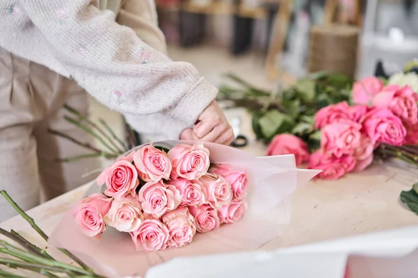Florist at work. .Summer bouquet of roses. Learning flower arranging, making beautiful bouquets with your own hands. Flowers delivery. High quality photo