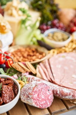 Table full of mediterranean appetizers, tapas or antipasto. Assorted Italian food set. Delicious snack on party or picnic time. Meat and cheese. Italian style banquet. . High quality photo