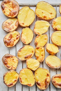 Potato wedges, oven roasted, a close-up in a baking tray. Home cooking. Healthy food, cooked without oil and salt. High quality photo