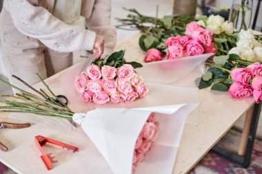 Florist at work. .Summer bouquet of roses. Learning flower arranging, making beautiful bouquets with your own hands. Flowers delivery. High quality photo