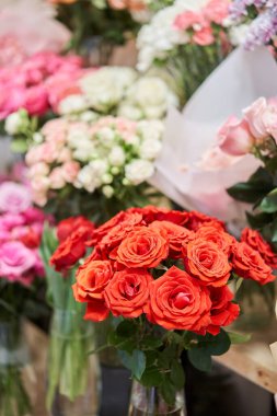Flower shop concept. Different varieties fresh spring flowers in refrigerator room for flowers. Bouquets on shelf, florist business. High quality photo