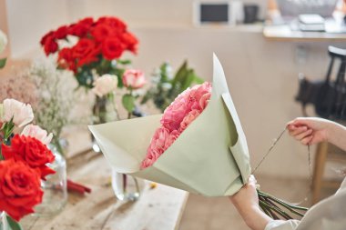 Florist at work. .Summer bouquet of roses. Learning flower arranging, making beautiful bouquets with your own hands. Flowers delivery. High quality photo