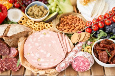 Table full of mediterranean appetizers, tapas or antipasto. Assorted Italian food set. Delicious snack on party or picnic time. Meat and cheese. Italian style banquet. . High quality photo