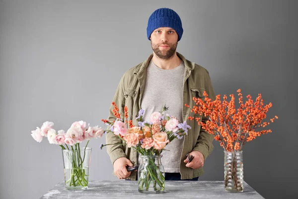 Portrait of a Male florist. Flowers bunch, set for home. Fresh cut flowers for decoration home. European floral shop. Delivery fresh cut flower