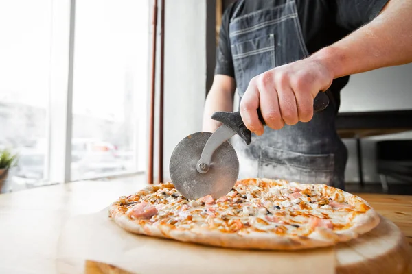 Großaufnahme Hand Des Chefs Bäcker Einheitlichen Blauen Schürze Schneidet Pizza — Stockfoto