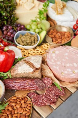 Table full of mediterranean appetizers, tapas or antipasto. Assorted Italian food set. Delicious snack on party or picnic time. Meat and cheese. Italian style banquet. . High quality photo