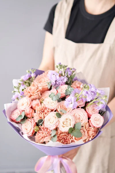 Beautiful mono bouquet of flowers in woman hand. Floral shop concept . Beautiful fresh cut bouquet. Flowers delivery.