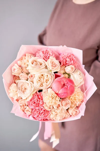 Beautiful mono bouquet of flowers in woman hand. Floral shop concept . Beautiful fresh cut bouquet. Flowers delivery.