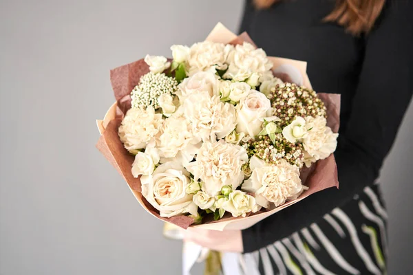 Beautiful mono bouquet of flowers in woman hand. Floral shop concept . Beautiful fresh cut bouquet. Flowers delivery.