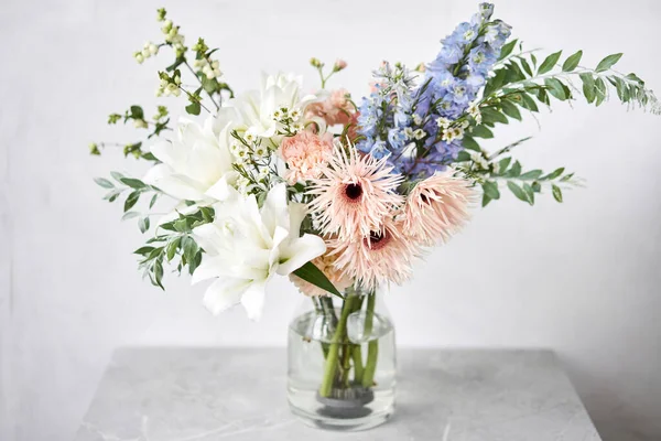 Finished flower arrangement in a vase for home. Flowers bunch, set for interior. Fresh cut flowers for decoration home. European floral shop. Delivery fresh cut flower
